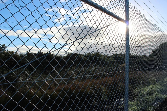 Why does the stadium use a chain link fence instead of a welded wire mesh?